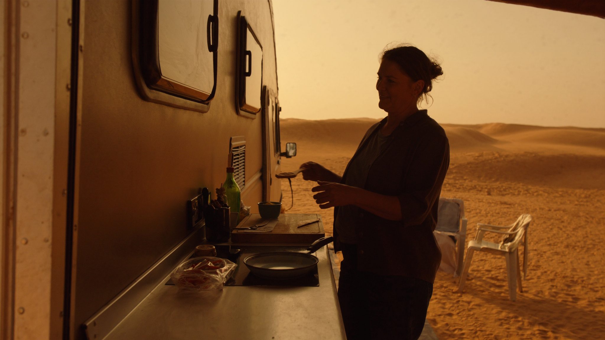 A family cooking at the trailer's outdoor kitchen